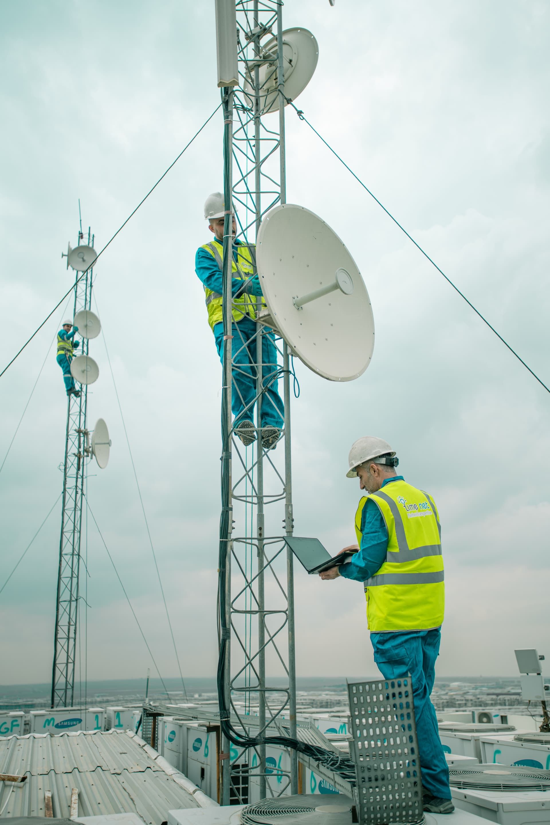Field engineers installing telecoms equipment on a mast
