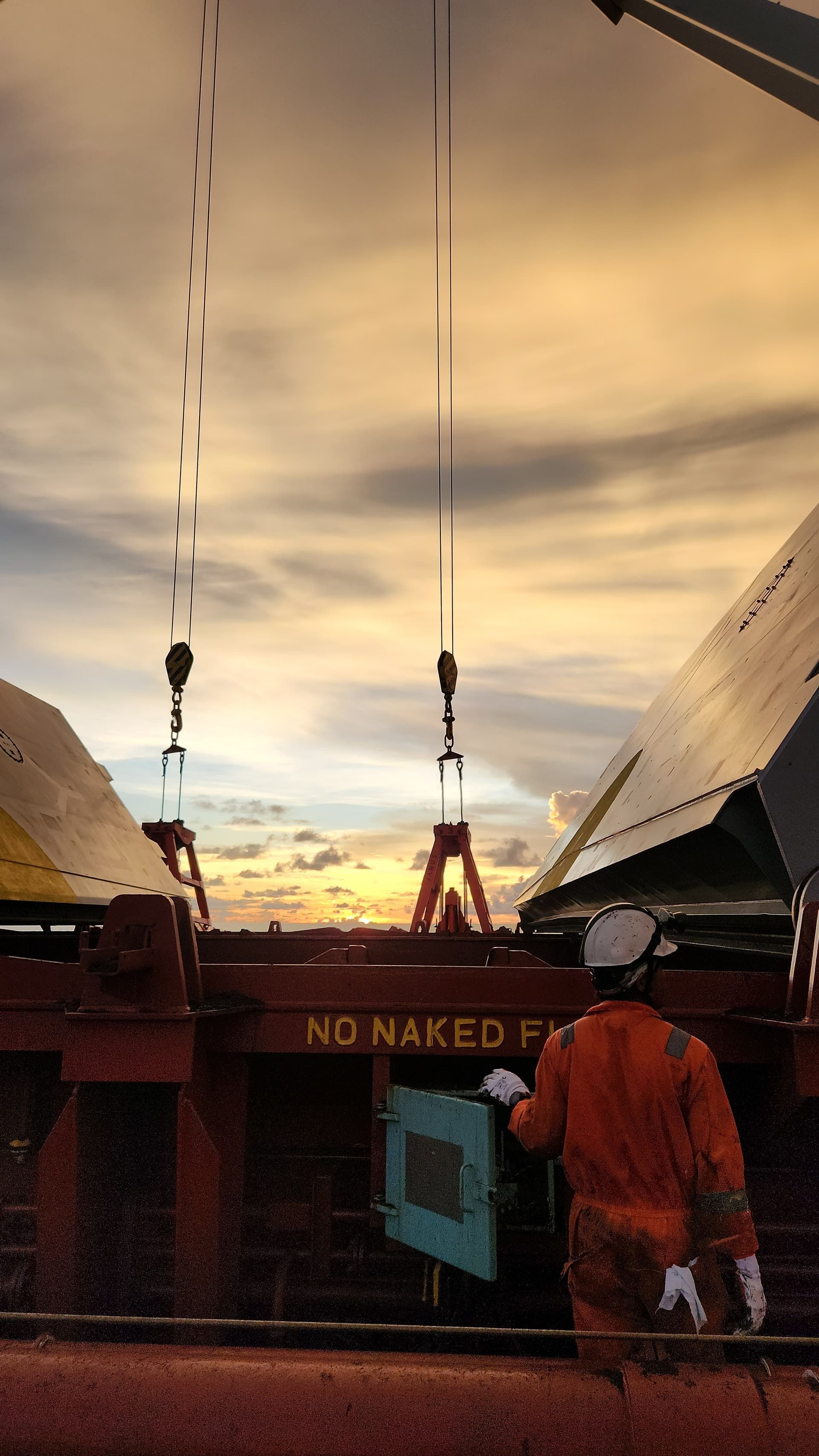 Marine engineer on a vessel at sunset